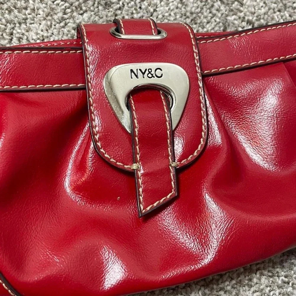 Red leather clutch handbag with silver hardware